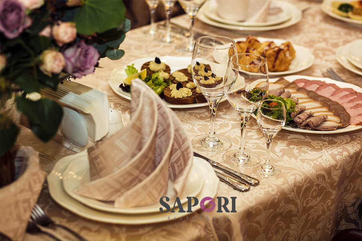 Elegant Italian dining table setting with wine glasses, candles, and fine cuisine at Sapori Ristorante in Montclair, NJ