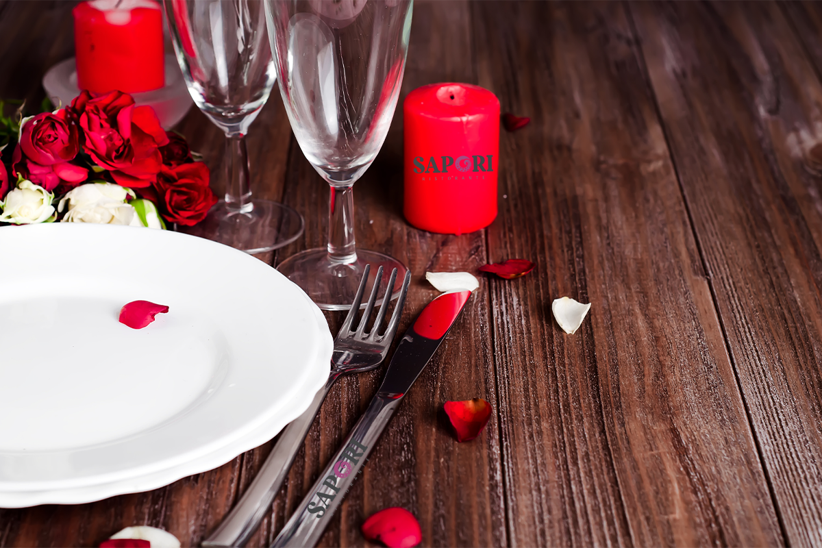 Romantic Italian dinner table with candles, wine, and rose petals at Sapori Montclair